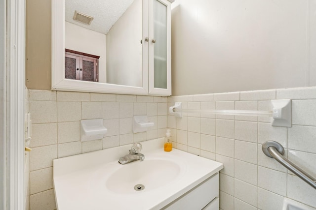 bathroom featuring vanity and a textured ceiling