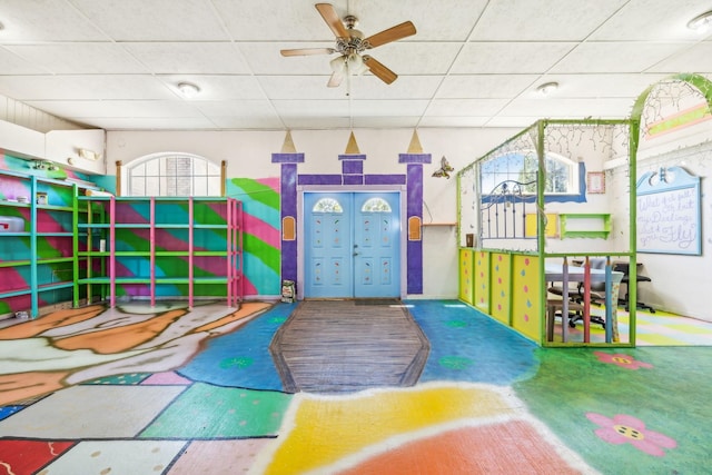 playroom featuring a paneled ceiling and ceiling fan