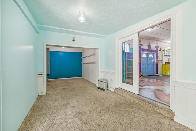 carpeted spare room with a textured ceiling