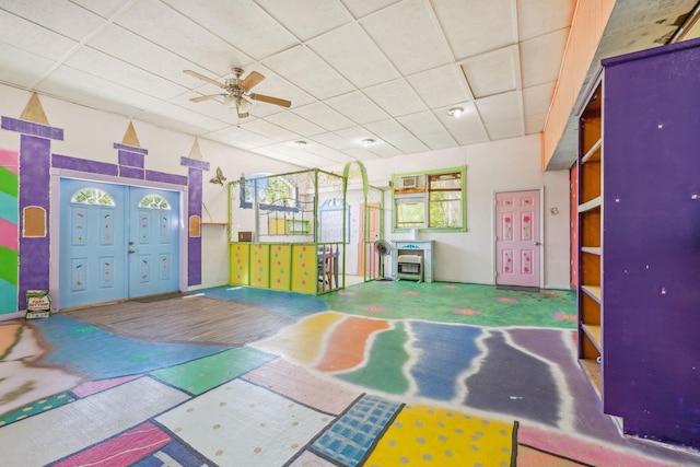 recreation room featuring a paneled ceiling and ceiling fan