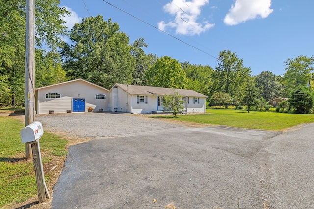 ranch-style home with a front lawn