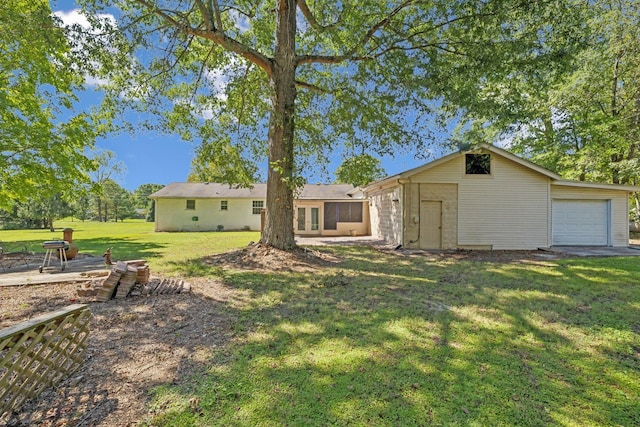 rear view of property with a lawn and a garage