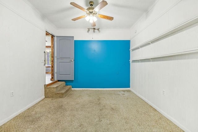 empty room with carpet, ceiling fan, and crown molding