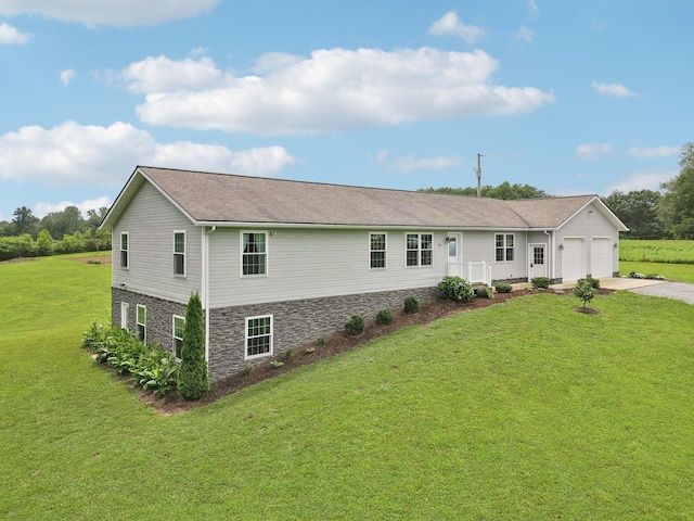 view of front of property featuring a garage and a front lawn