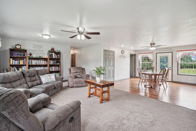 living room featuring light carpet and ceiling fan