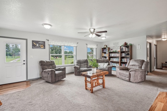 carpeted living room with a wealth of natural light and ceiling fan