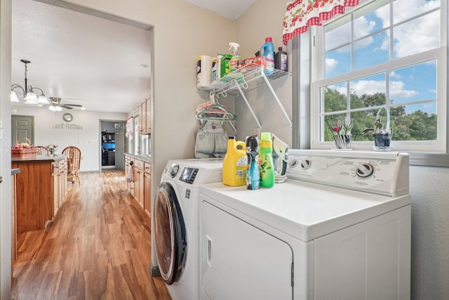 washroom featuring ceiling fan, light hardwood / wood-style floors, and washing machine and dryer