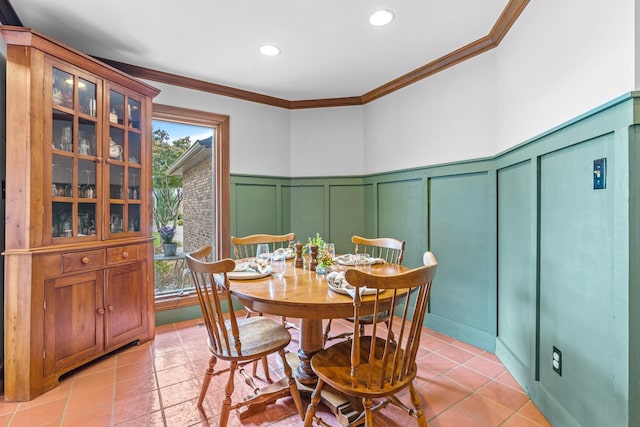 dining room featuring light tile patterned flooring, crown molding, and a wealth of natural light