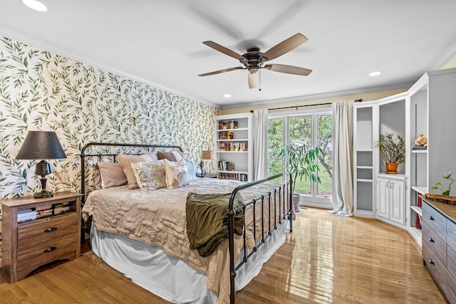 bedroom featuring ceiling fan, light hardwood / wood-style floors, and ornamental molding