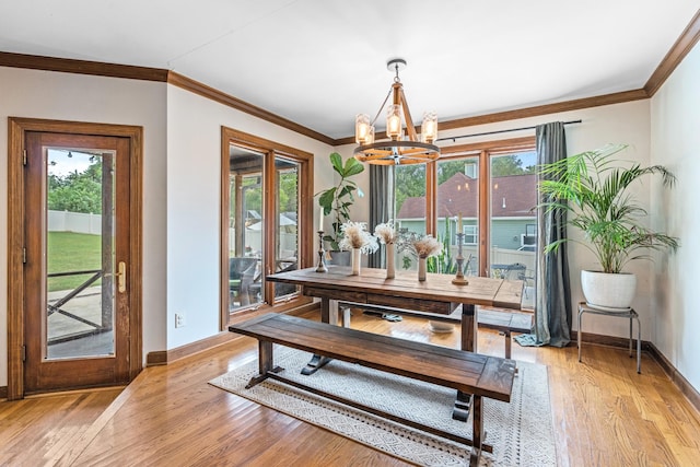 dining room with a notable chandelier, a wealth of natural light, and light hardwood / wood-style flooring