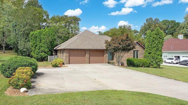 view of front of property with a garage and a front lawn