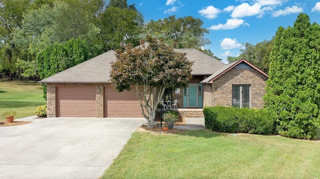 view of front of home with a front yard and a garage