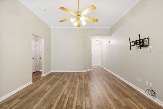 unfurnished room with hardwood / wood-style floors, ceiling fan, and crown molding