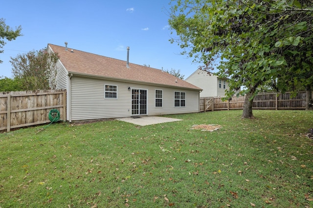 rear view of property featuring a patio area and a yard