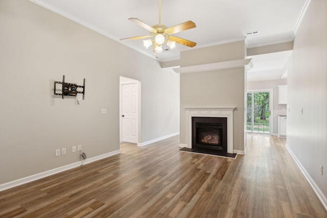 unfurnished living room featuring ceiling fan, dark hardwood / wood-style floors, and ornamental molding