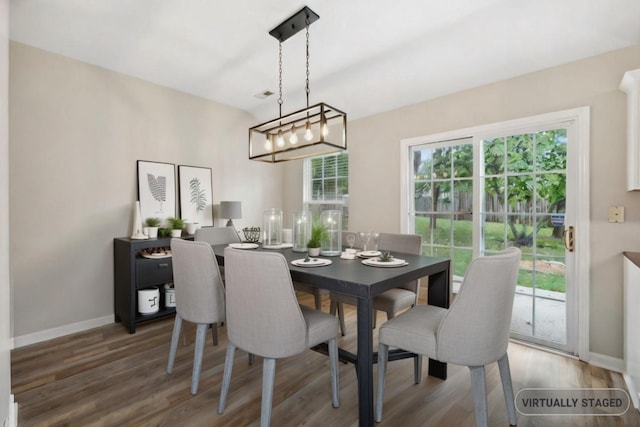 dining space with dark hardwood / wood-style floors