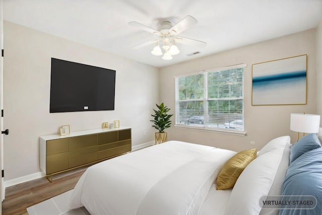 bedroom with ceiling fan and hardwood / wood-style floors