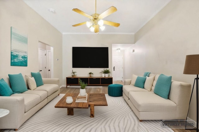 living room with crown molding, ceiling fan, and wood-type flooring