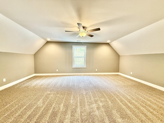 bonus room with carpet floors, vaulted ceiling, and ceiling fan