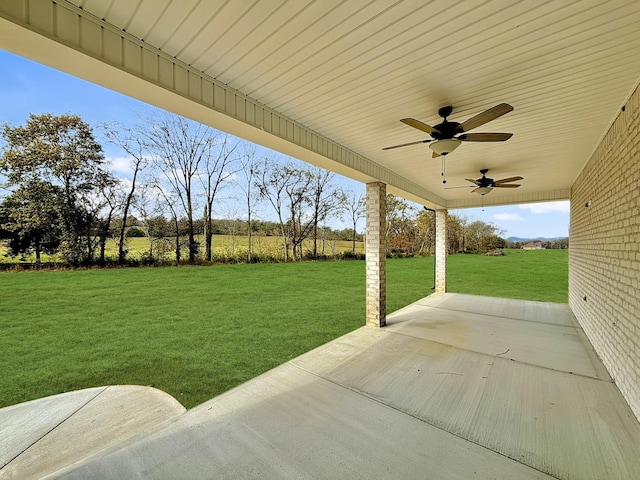 view of yard with ceiling fan and a patio