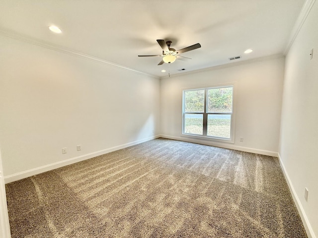 carpeted spare room with ceiling fan and ornamental molding