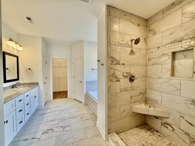 bathroom with vanity and shower with separate bathtub