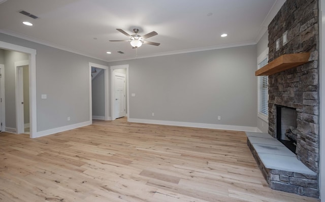 unfurnished living room with light hardwood / wood-style flooring, a stone fireplace, ceiling fan, and crown molding