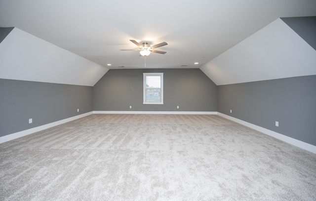 bonus room featuring ceiling fan, light colored carpet, and lofted ceiling