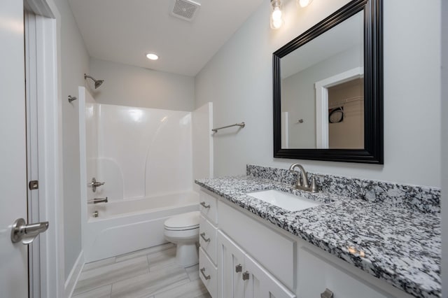 full bathroom featuring vanity, toilet, and  shower combination