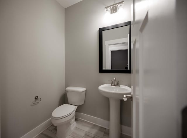 bathroom with tile patterned floors, sink, and toilet