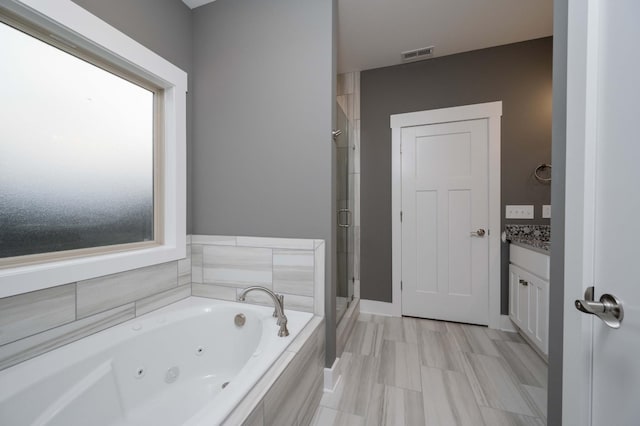 bathroom with shower with separate bathtub and vanity