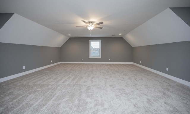 additional living space featuring light colored carpet, vaulted ceiling, and ceiling fan