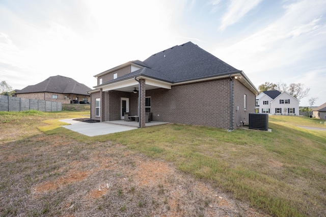 rear view of house with a lawn, ceiling fan, cooling unit, and a patio