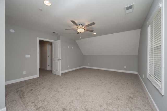 bonus room featuring ceiling fan, light colored carpet, and vaulted ceiling