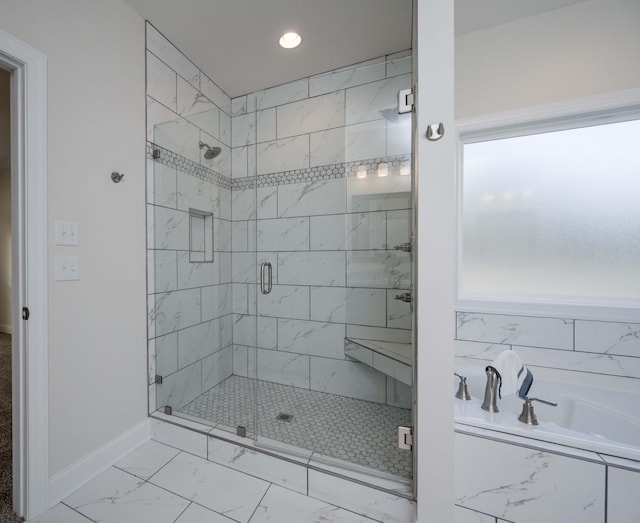 bathroom featuring separate shower and tub