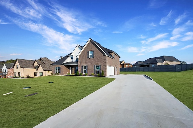 view of front of property featuring a front yard and a garage