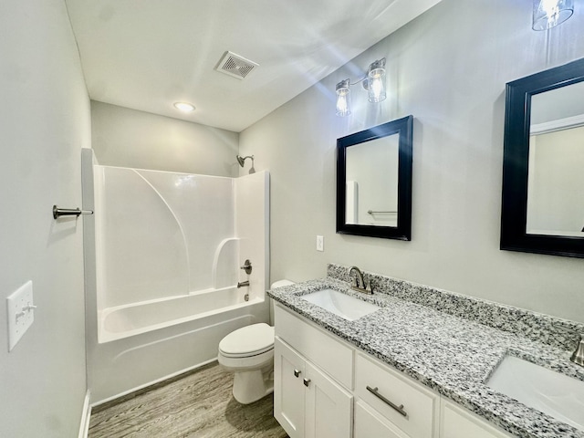 full bathroom with shower / bathing tub combination, vanity, toilet, and hardwood / wood-style floors