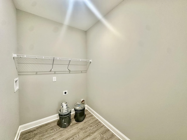 washroom featuring hookup for a washing machine, hardwood / wood-style floors, and hookup for an electric dryer