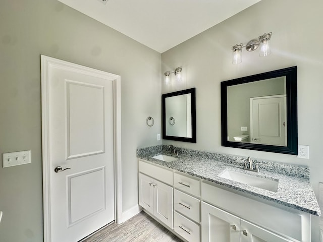 bathroom with hardwood / wood-style floors and vanity