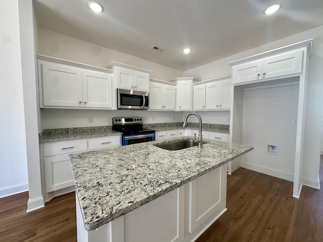 kitchen with a center island with sink, white cabinetry, sink, and appliances with stainless steel finishes