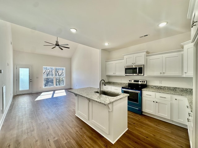 kitchen with white cabinets, stainless steel appliances, light stone countertops, and sink