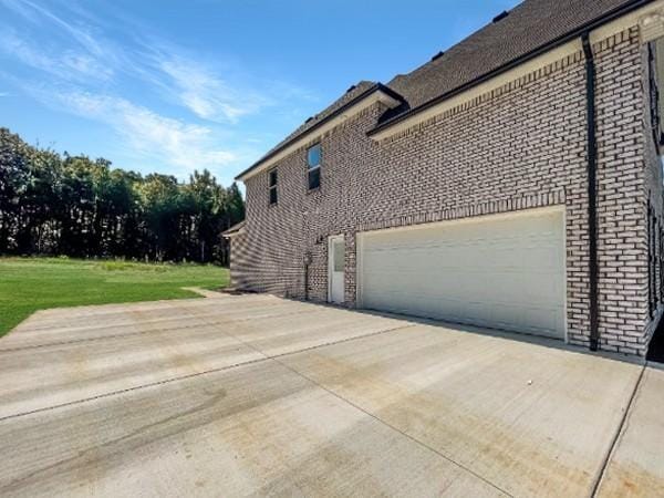 view of property exterior with a lawn and a garage