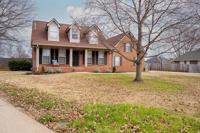 new england style home featuring a front yard