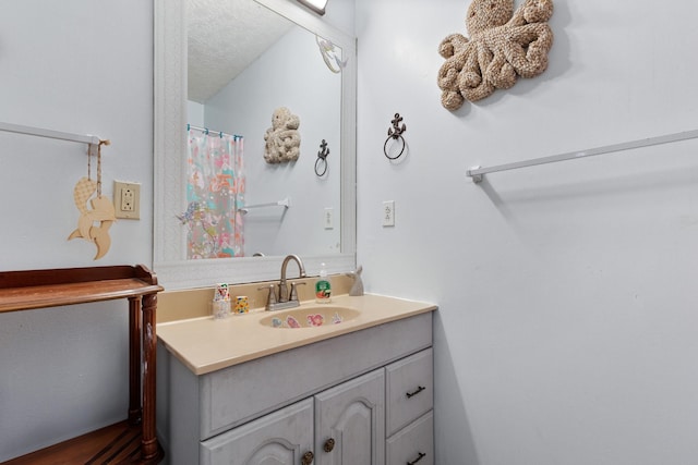 bathroom featuring vanity and a textured ceiling