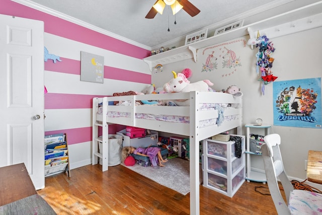 bedroom with ceiling fan, ornamental molding, and hardwood / wood-style flooring