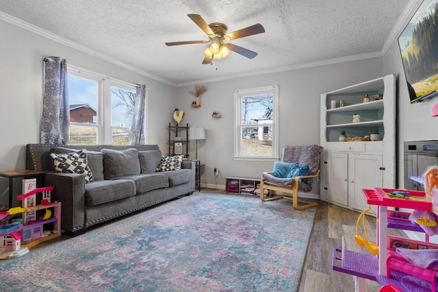 living room with a textured ceiling, hardwood / wood-style flooring, and ornamental molding