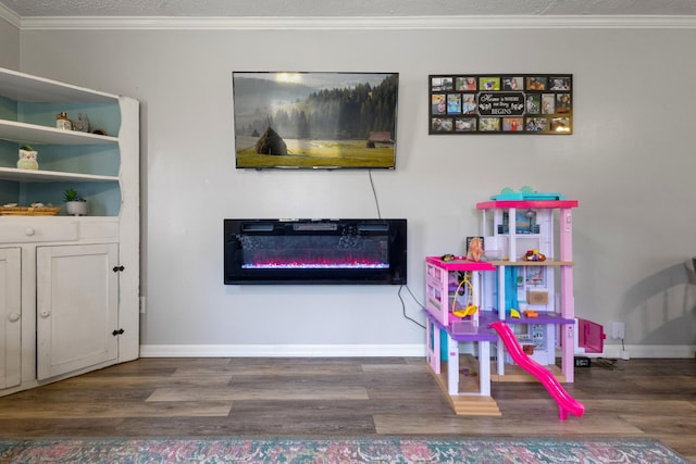 rec room featuring a textured ceiling, dark hardwood / wood-style floors, and ornamental molding