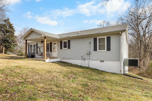 view of front facade featuring a porch, central air condition unit, and a front yard