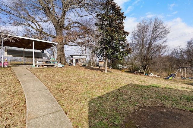 view of yard with a playground and a carport