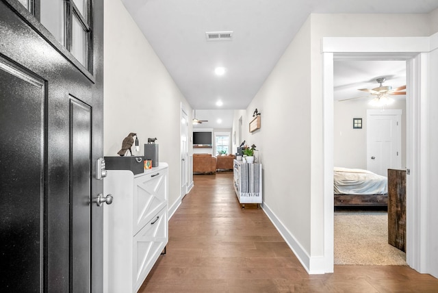 corridor featuring hardwood / wood-style floors